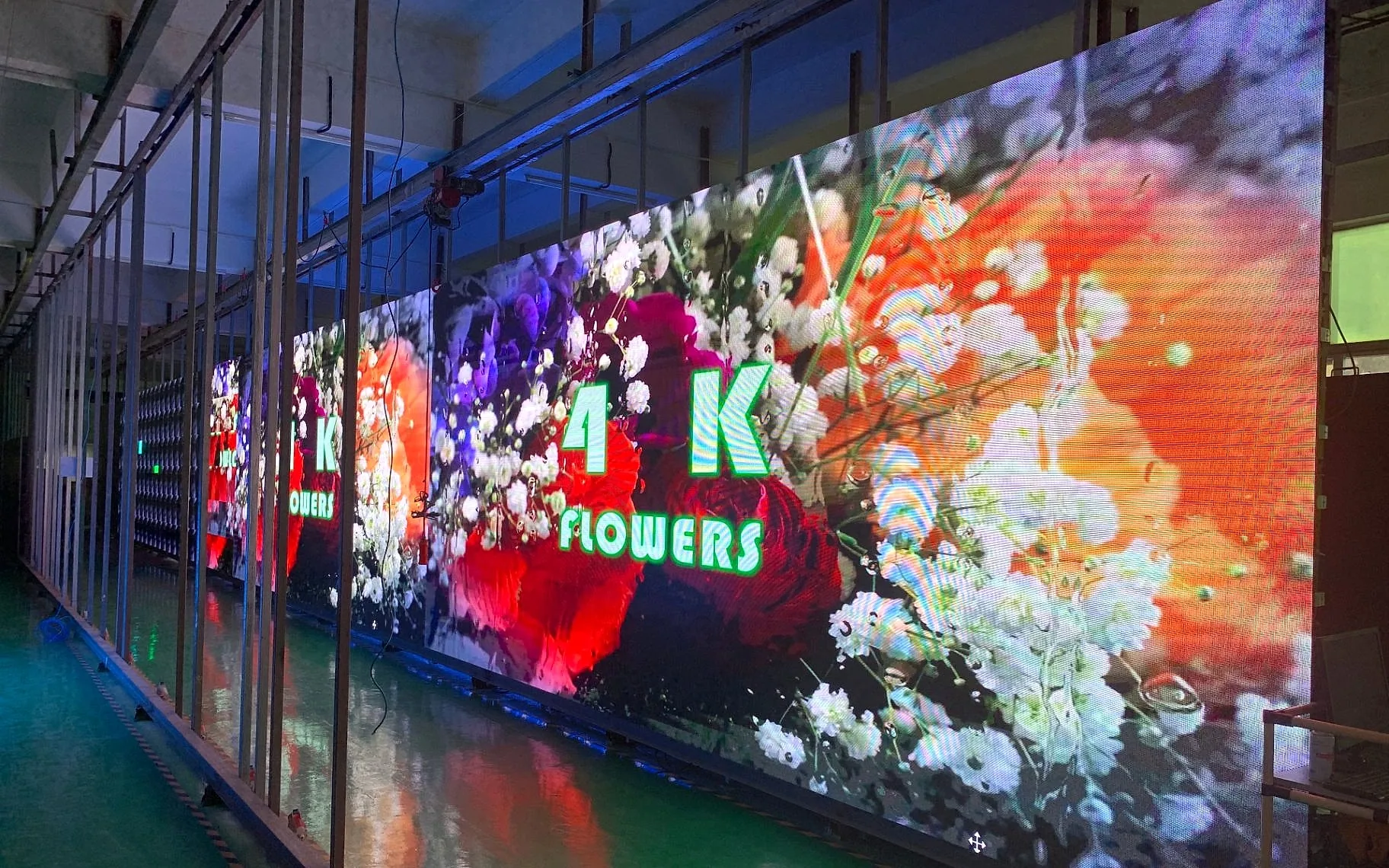 Green Hi-Tech outdoor P3 fixed LED display running 4K content in factory aging test.