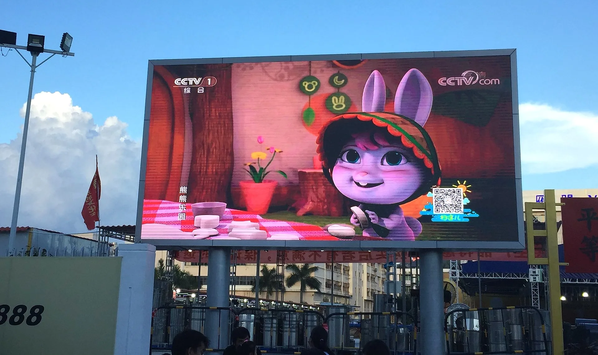 Green Hi-Tech outdoor P4 fixed LED display installed on a city plaza showing live broadcast